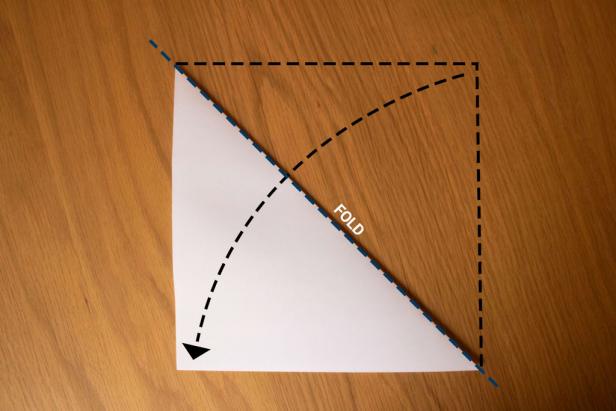 Fold a square sheet of paper in half on the diagonal.