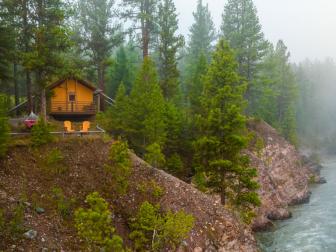 A glamping tent surrounnded by trees and overlooking a river at The Resort at Paws Up in Montana