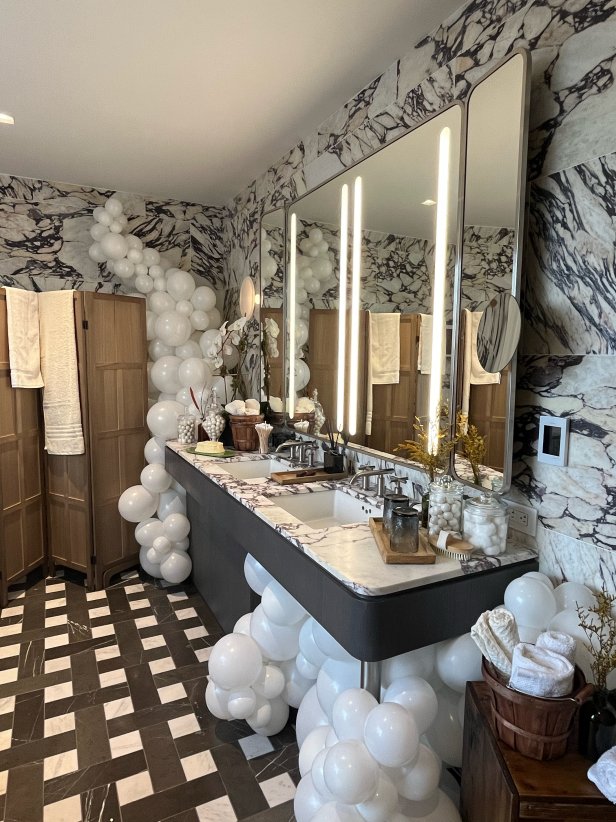 Neutral Bathroom With Marble Walls and Balloons