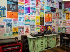 Differently-sized letterpress entertainment posters on a wall. 