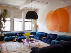 A photo of a cozy and colorful family room with plush blue sofa.