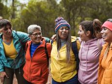 Group of women having fun together during a hiking day at in a mountain forest