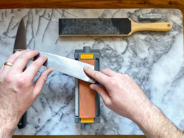The next step in sharpening a knife is to progress to a finer stone once you've formed an even burr across the entire edge of the stone.