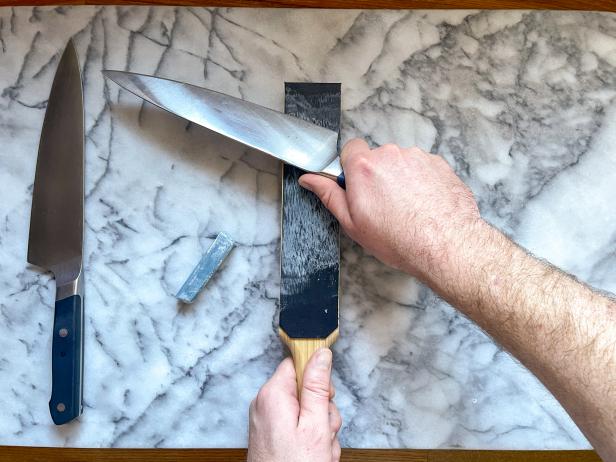 The next step in giving a knife a razor sharp edge is to strop the knife on a piece of leather with sharpening compound.