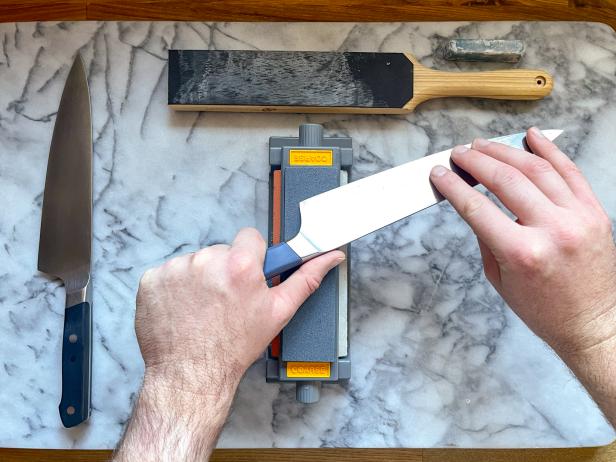 The next step in sharpening a knife on a sharpening stone is to flip the knife over and start with the other side's heel.