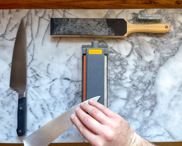 The next step in sharpening a knife's opposite side is to carefully sharpen the tip to create an even bevel.