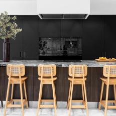 Black Modern Kitchen With Caned Barstools