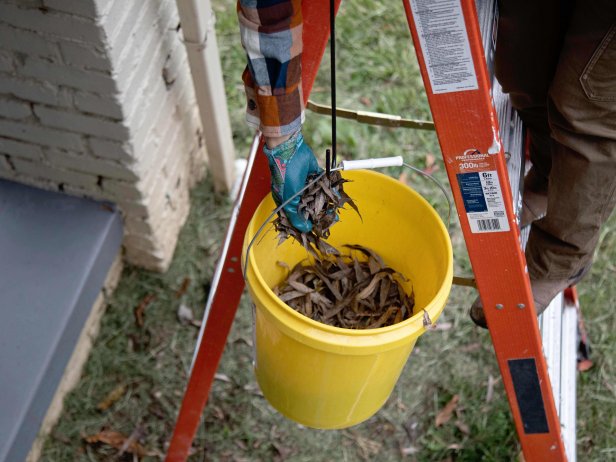 how to clean gutters: scoop debris