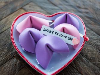 Pink and purple foam fortune cookies on a heart shaped plate 