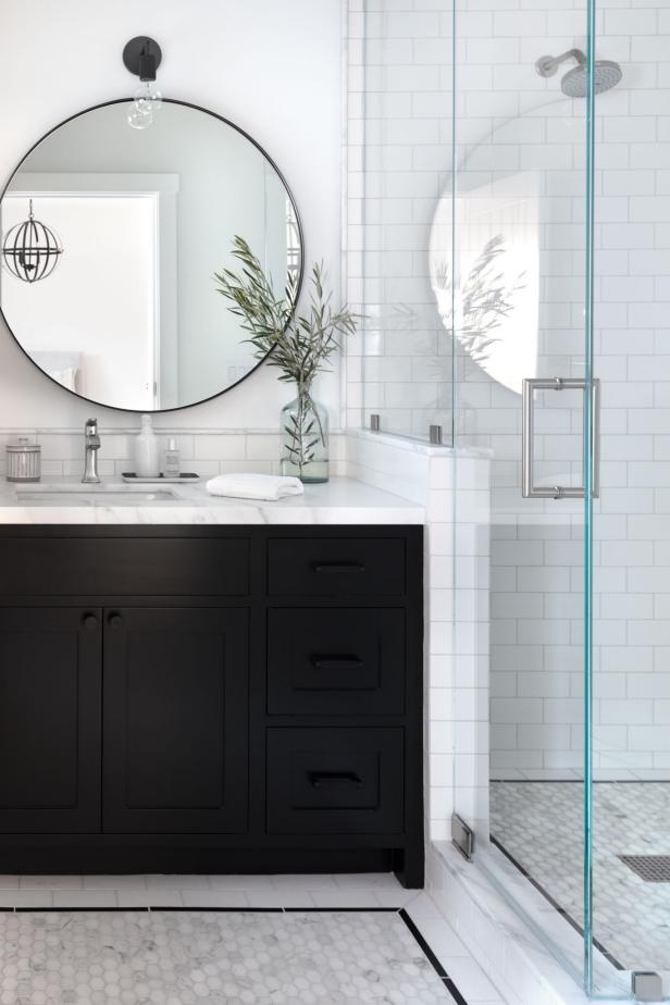 This Renovated Bathroom Has White Tiles With a Contrasting Black Vanity ...