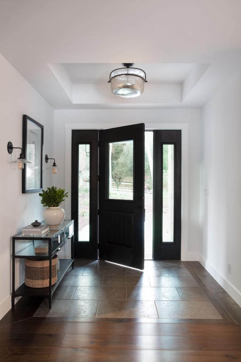 Petite Entryway With Black Door and Inset Tile Detail