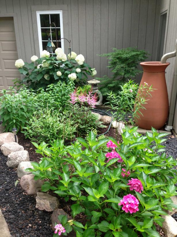 This environmentally-friendly landscape from HGTV Magazine uses a stylish rain barrel that uses recycled rain to water the plants.
