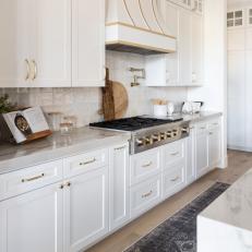 White Transitional Chef Kitchen With Brass Accents