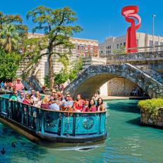 Boat Carrying Passengers Along a River