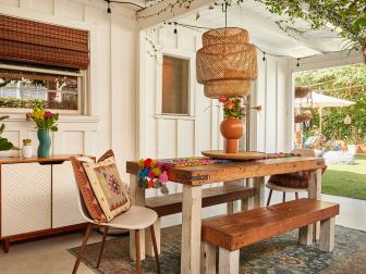Long wooden table with benches and woven pendant.