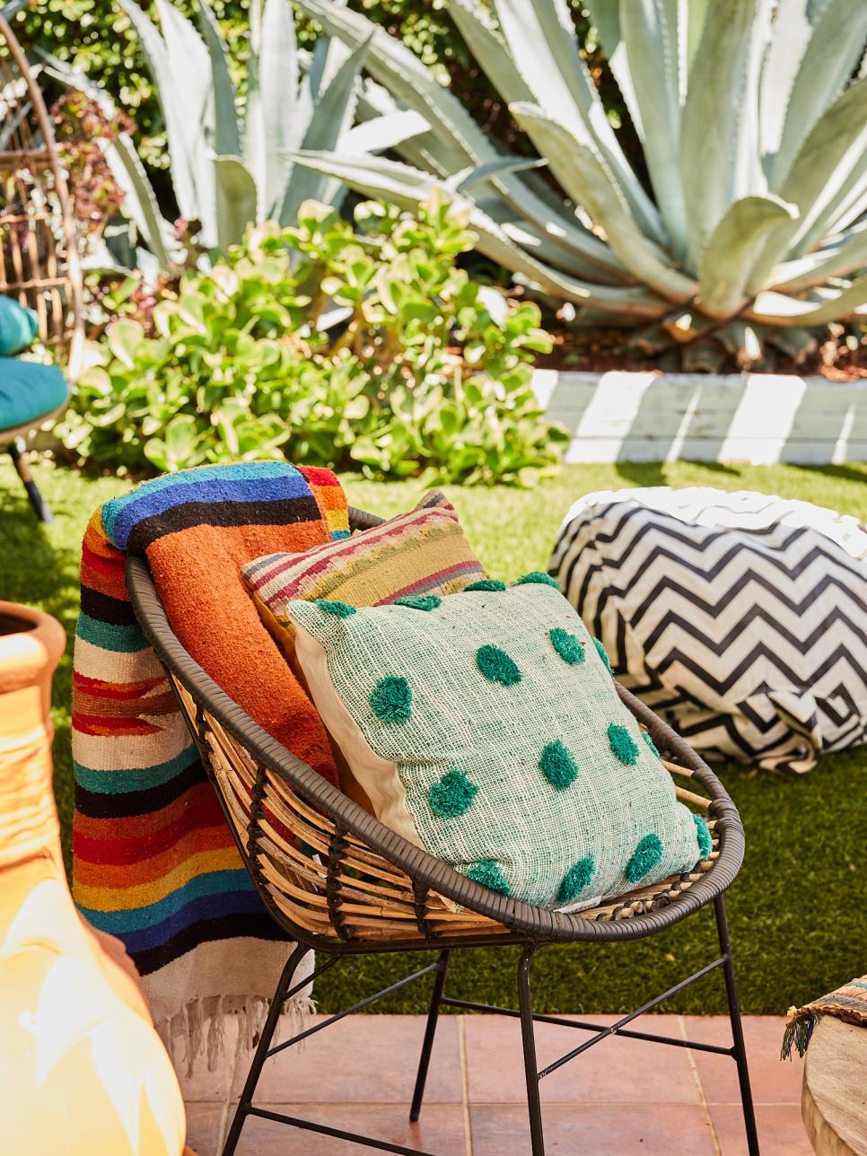 Outdoor Wicker Chair With Colorful Blanket and Cushions HGTV
