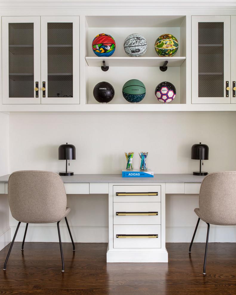 White built-in cabinets with black lamps and colorful basketballs.