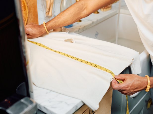The first step in washing a wool sweater at home is to measure the length and note the measurements.