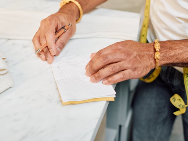 The next step in washing a wool sweater at home is to note its measurements in a notebook.