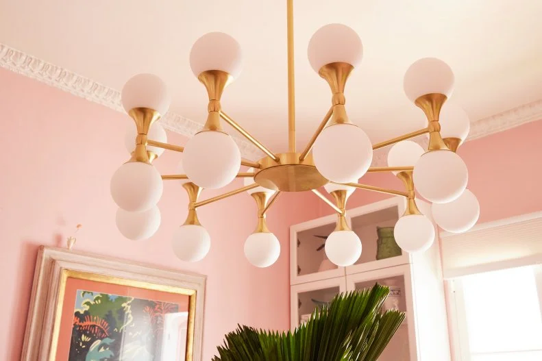 Gold trimmed, modern chandelier with globe lights
