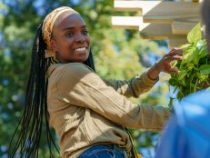 Host Jamila Norman hangs a plant in season 3 of "Homegrown" on Magnolia Network.