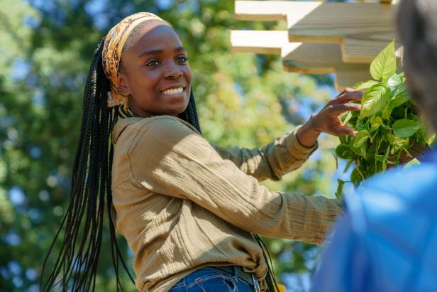 Host Jamila Norman hangs a plant in season 3 of "Homegrown" on Magnolia Network.