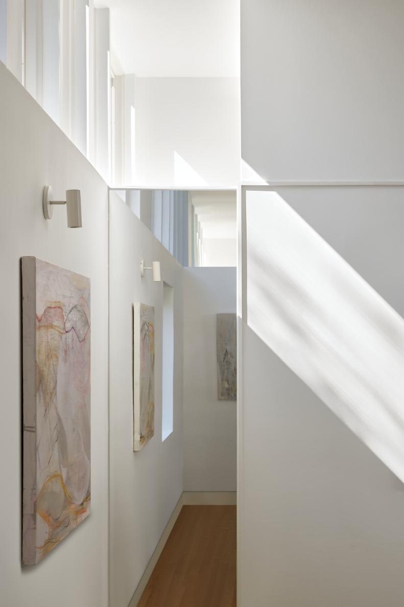 This white hallway features lots of windows and light.
