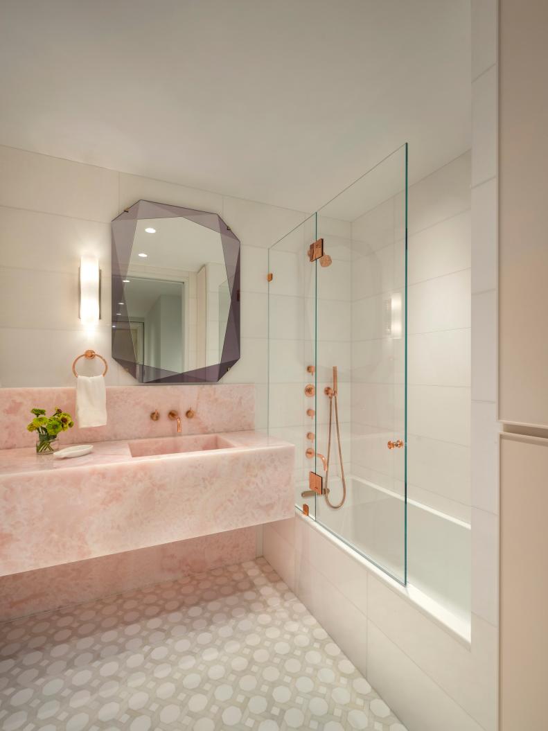 This bathroom features a pink marble sink vanity.