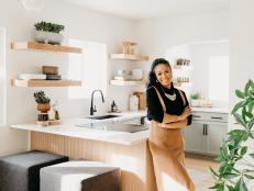 A photo of product designer Candice Luter standing in the kitchen of her Iowa home.