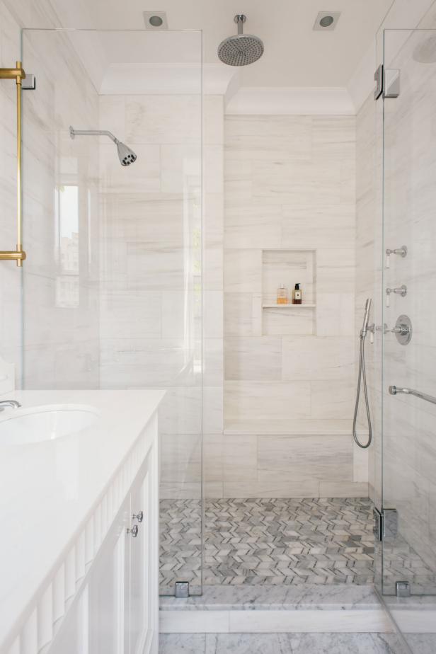 Marble-Lined Shower With Glass Doors and Brass Hardware | HGTV