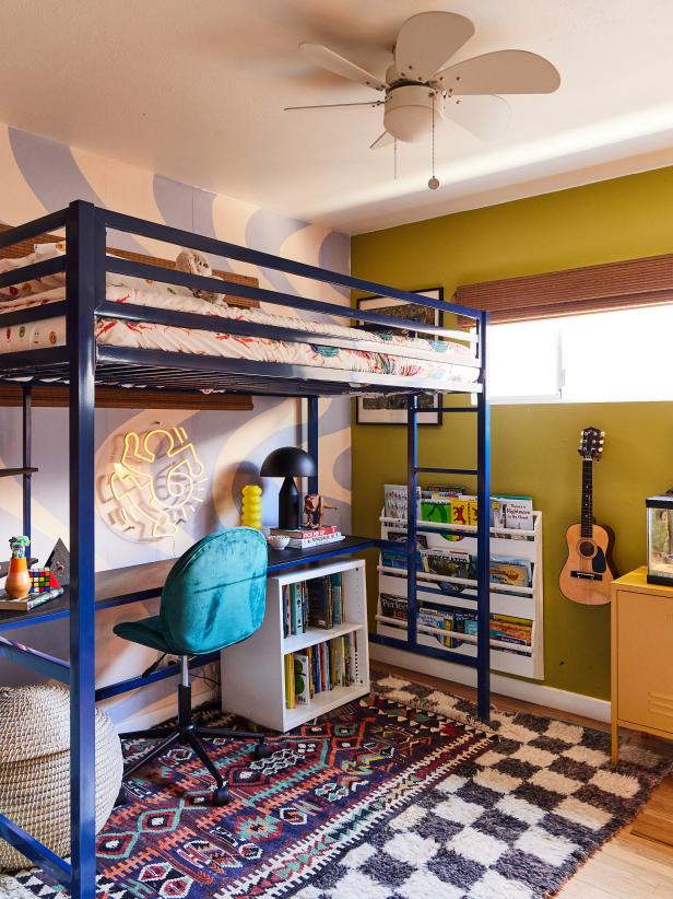 Bedroom with blue loft bed and checkerboard rug. 
