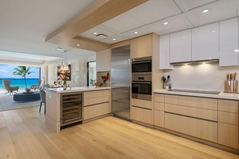 White Kitchen With Light Wood Floors and Cabinets