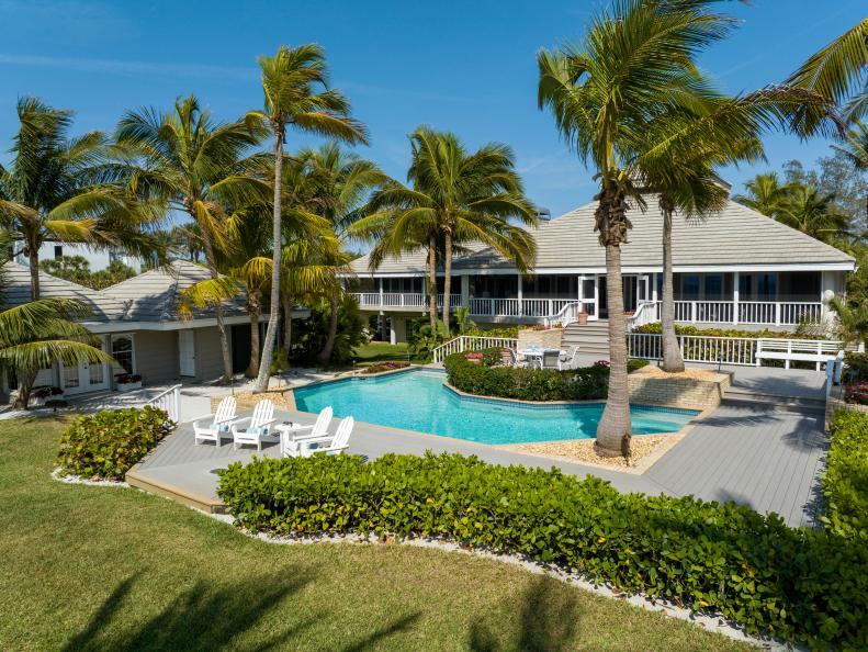 Beachfront Yard With a Pool and Palm Trees