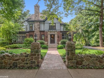 Mature Trees Over Tudor Home, Brick Walkway, Triangular Gable