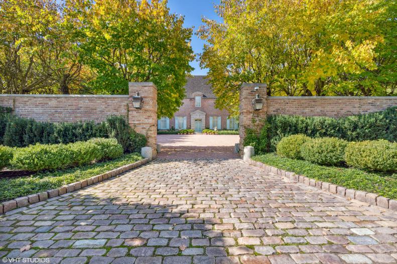 Stone Driveway Leading To French Country Home