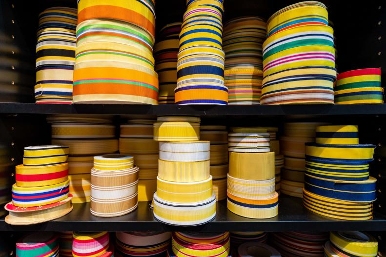 Stacks of Colorful Ribbon on a Shelf