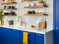 Modern, Eclectic Kitchen With Blue Cabinets and Floating Shelves