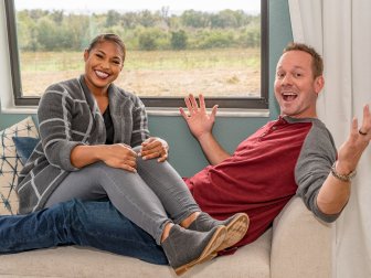 Hosts Brian and Mika Kleinschmdit smiling inside homeonwers Dustin and Maribel's completed dream home as seen on 100 Day Dream Home.