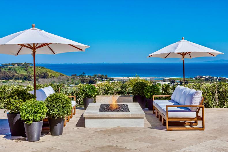 Chic, Coastal Patio With a Stone Fire Pit 