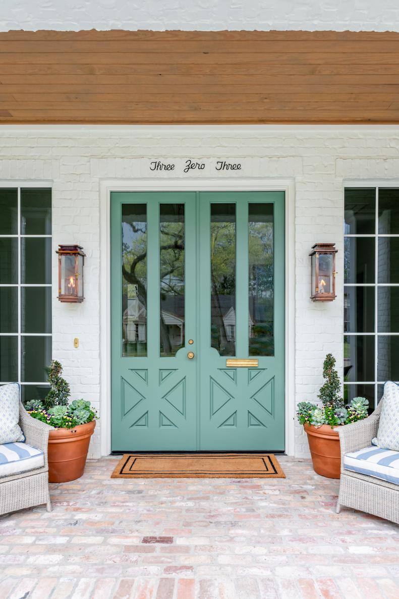 White Brick Home With Bright Green Front Doors