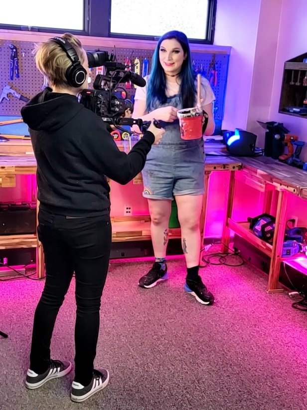 Woman Talks to Camera With Paint Can and Brush In Hand