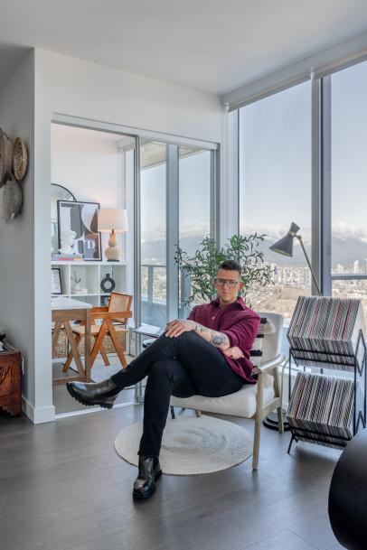 Man sitting beside glass window near high rise building photo