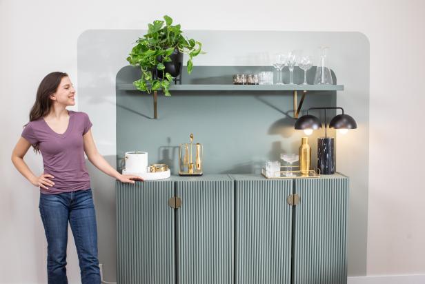 A Woman Standing Next to a Home Bar