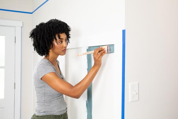 A Woman Painting Wall Trim Blue