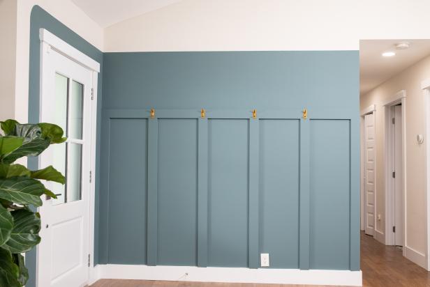 The next step in this DIY accent wall project is to install coat hooks on the horizontal trim board after the paint dries.