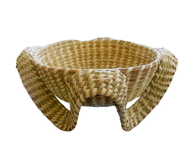 A handwoven basket with integrated pedestal-type legs and handles
