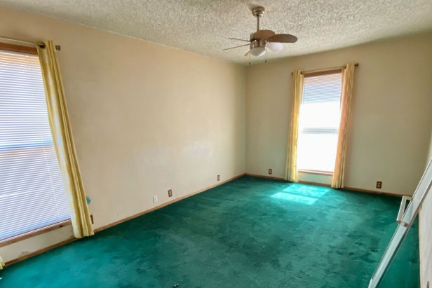 The A-frame upstairs bedrooms featured the same dated green carpet.