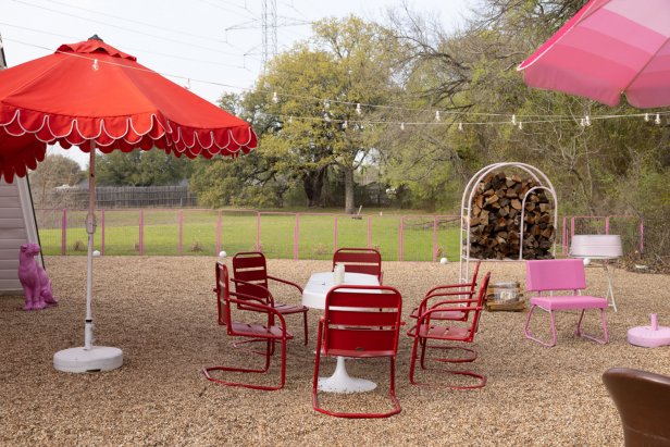 Peagravel Outdoor Area With One Long Table Surrounded by Metal Chairs