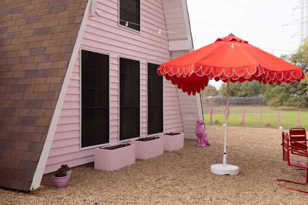 Large Patio Umbrella With Scalloped Trim in Front of Exterior Wall