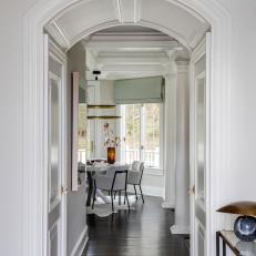 Bright White Entryway With Arched Doorframe
